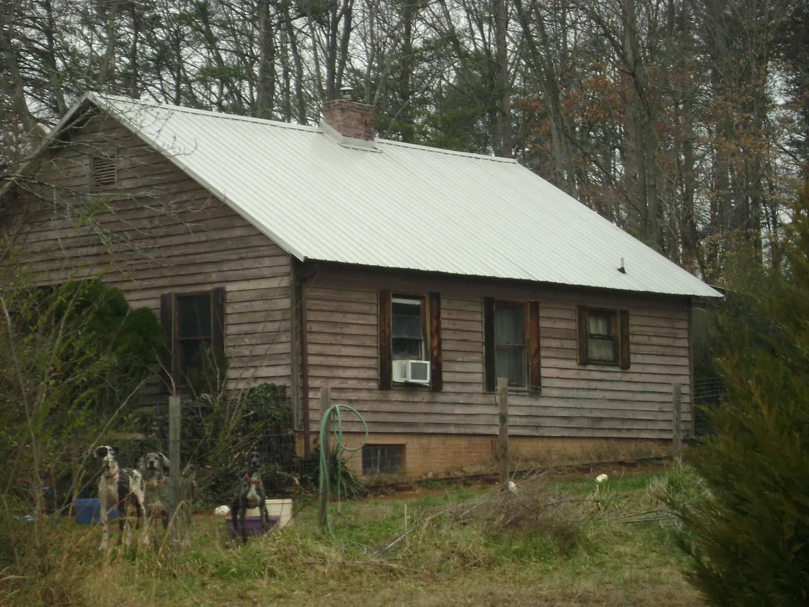 White metal roof on an old wood sided farmhouse, from a Metal Roof Installation job in Guide Rock